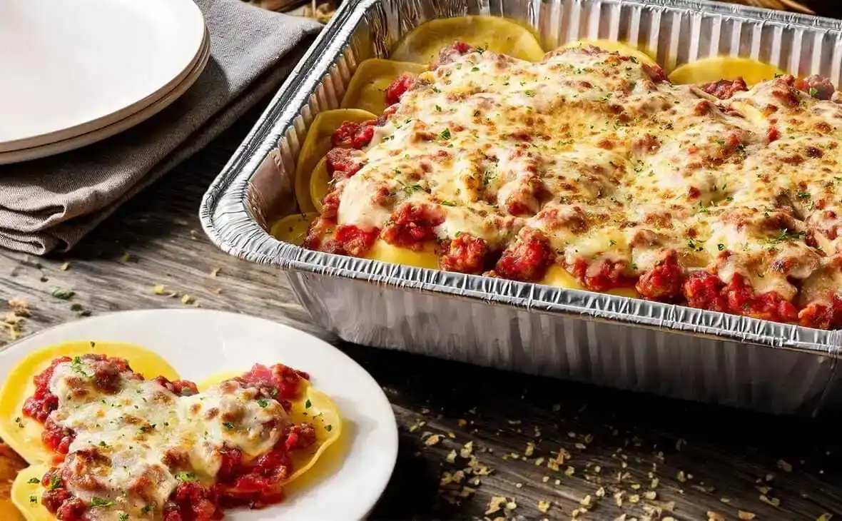 Olive Garden family-size Cheese Ravioli tray with marinara sauce and melted cheese topping
