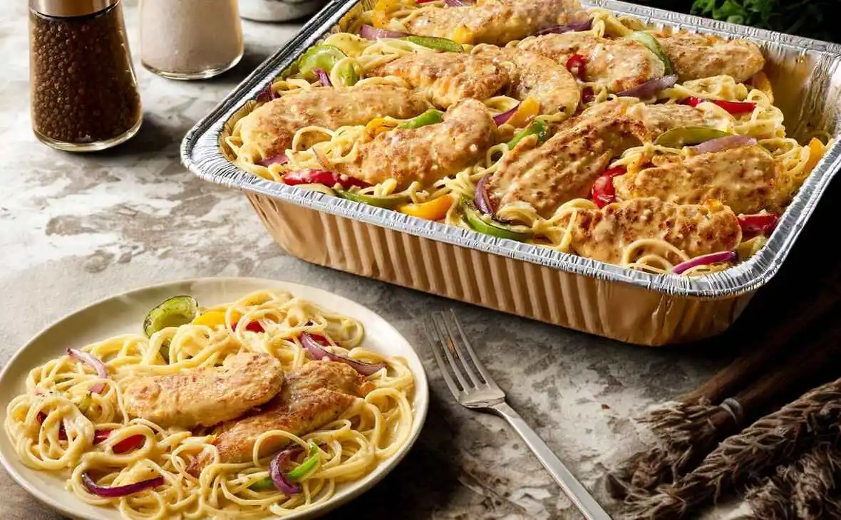 Olive Garden family-size Chicken Scampi tray with sautéed chicken, pasta, bell peppers, and onions
