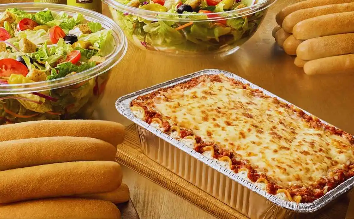 Olive Garden Family-Style Lasagna meal with large house salads and breadsticks