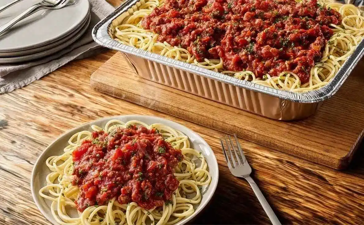 Olive Garden family-size Spaghetti with meat sauce tray topped with rich tomato and beef sauce