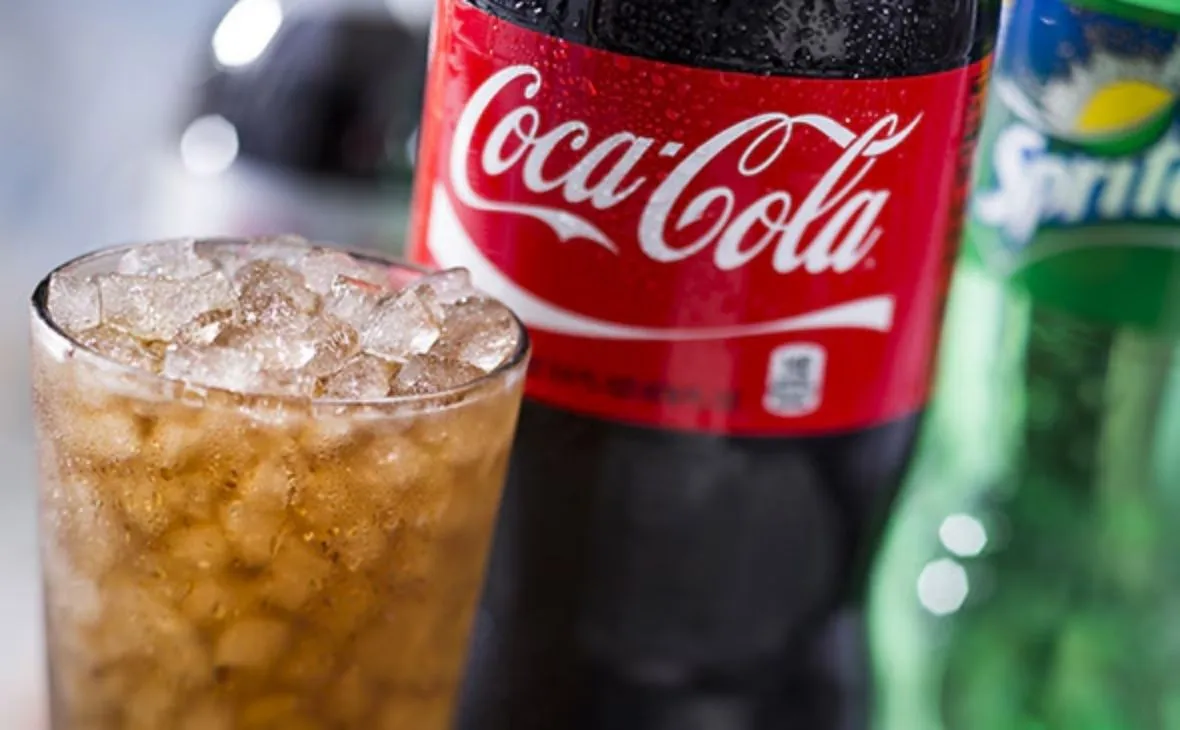 2-liter soda bottle served with a glass of soda and ice