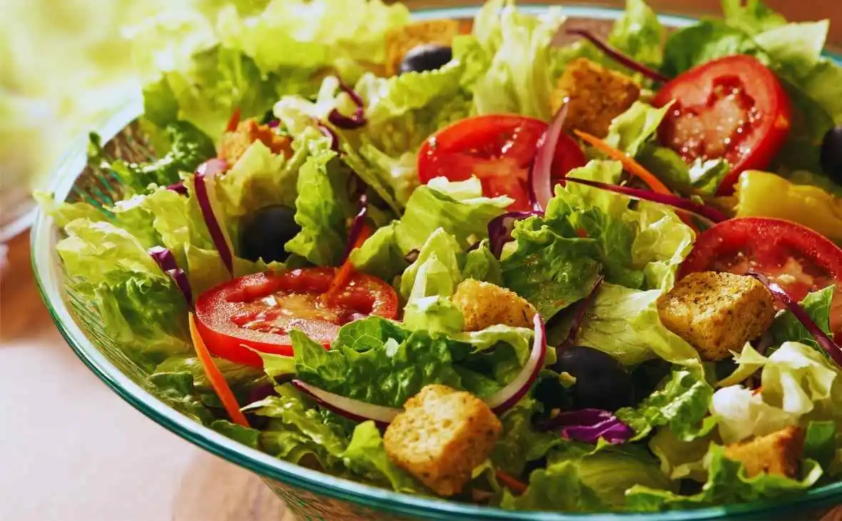 Olive Garden Famous House Salad with lettuce, tomatoes, olives, red onions, and croutons