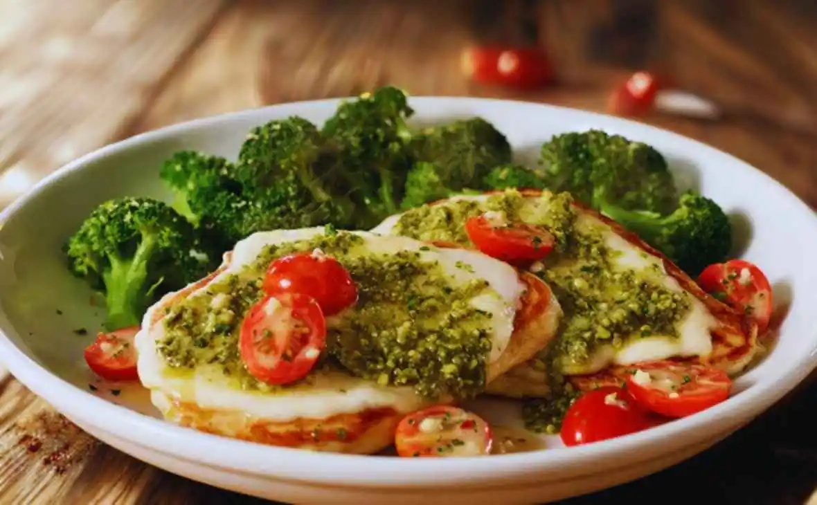 Olive Garden Grilled Chicken Margherita topped with pesto and mozzarella served with broccoli and cherry tomatoes