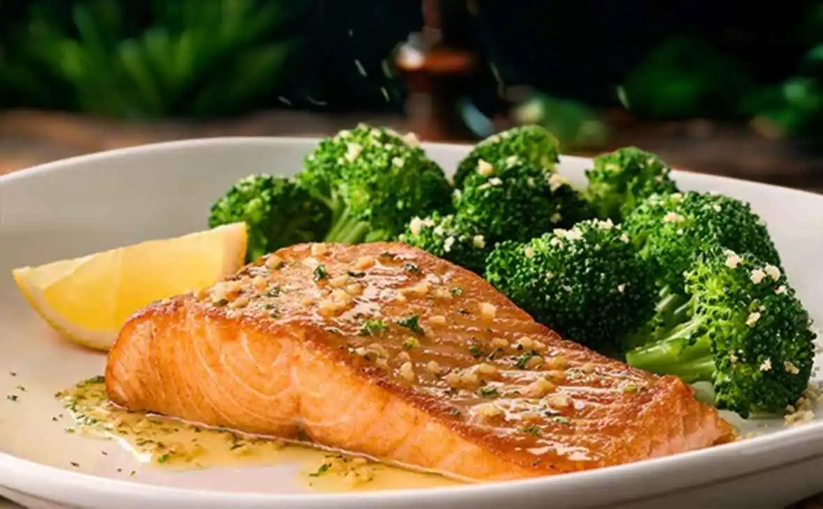Olive Garden Herb-Grilled Salmon served with steamed broccoli and lemon