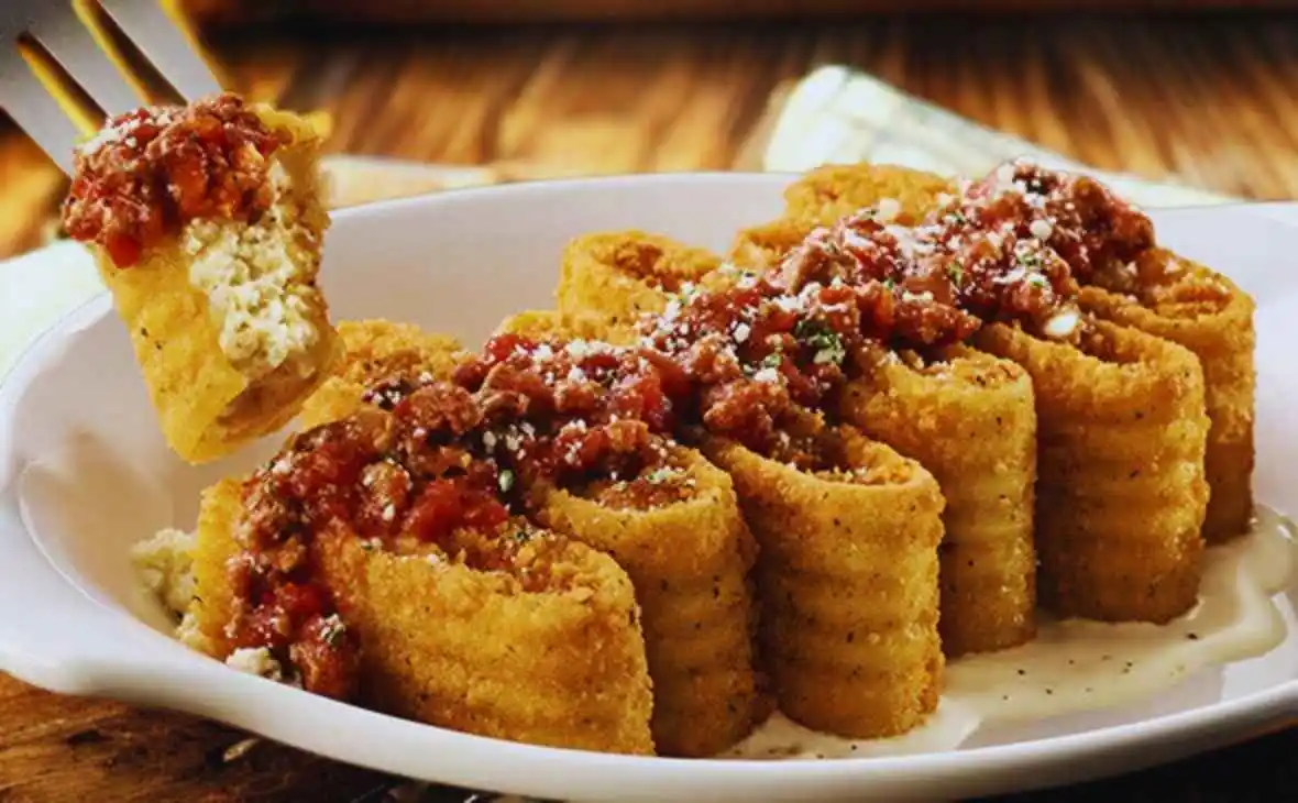 Olive Garden Lasagna Fritta topped with meat sauce and parmesan cheese