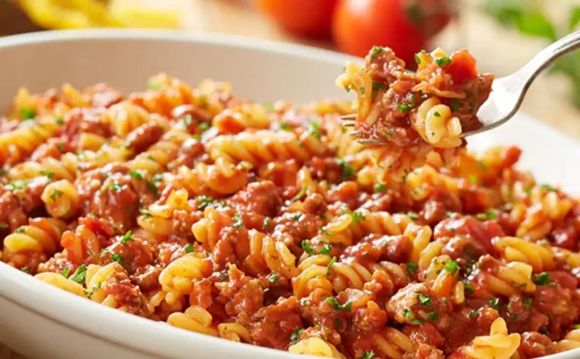 Rotini pasta served with rich tomato meat sauce