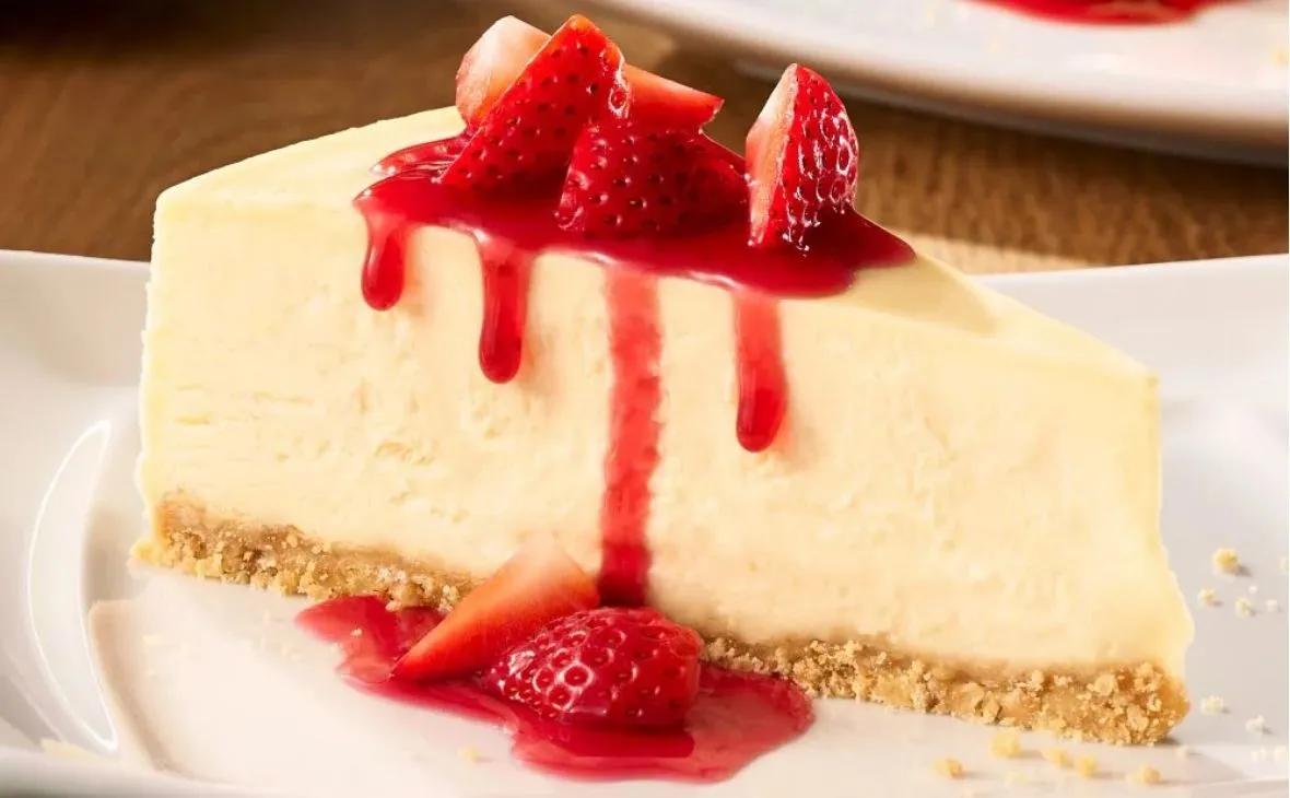 Olive Garden Sicilian cheesecake topped with fresh strawberries and sweet strawberry sauce